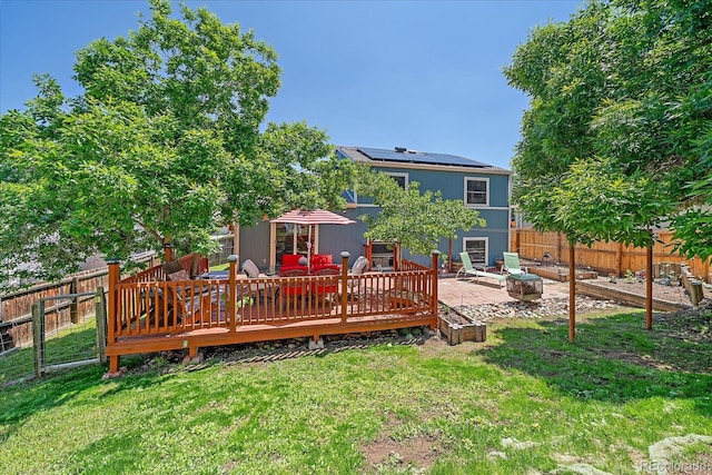 6085 S Parfet St, Littleton, CO 80127 - back of property featuring a fenced backyard, solar panels, a deck, and a patio