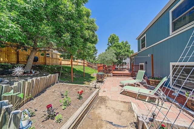 6085 S Parfet St, Littleton, CO 80127 - fenced backyard with a deck, a patio area, and a garden