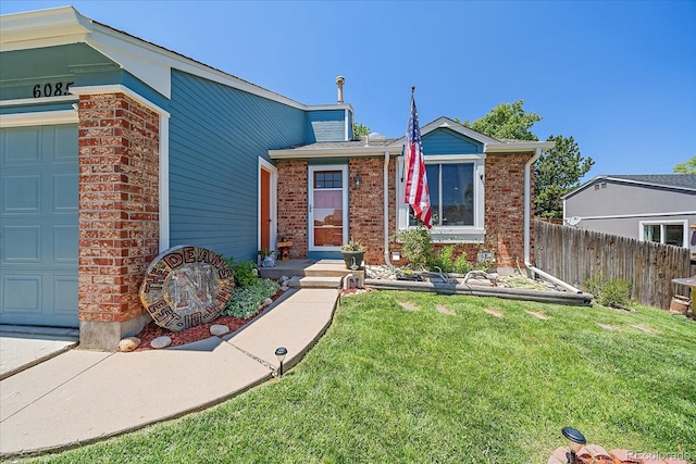 6085 S Parfet St, Littleton, CO 80127 - view of front of property with an attached garage and brick siding