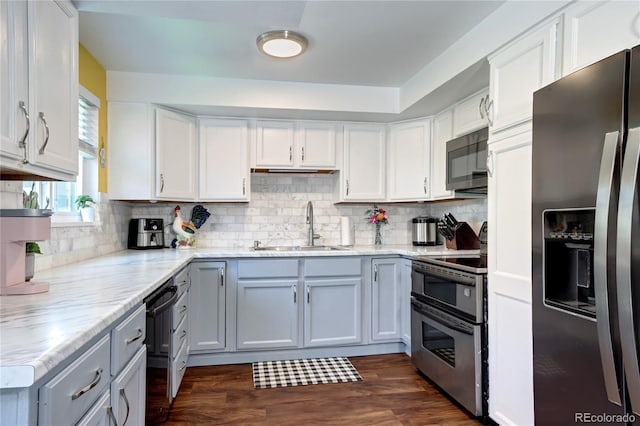 4856 E Hinsdale Pl, Centennial, CO 80122 - kitchen with black appliances, backsplash, white cabinetry, and dark wood-style floors