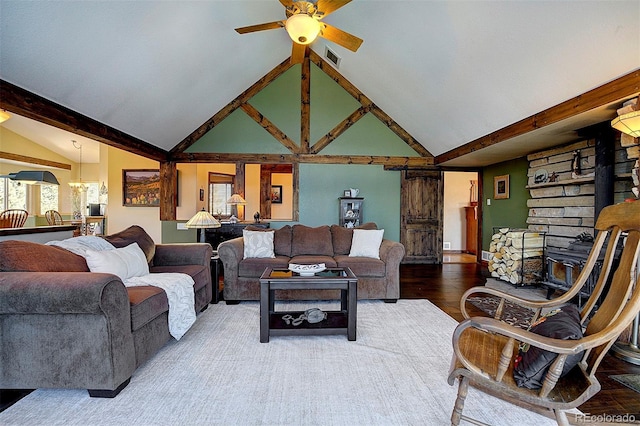 living room featuring wood-type flooring, vaulted ceiling with beams, and ceiling fan with notable chandelier