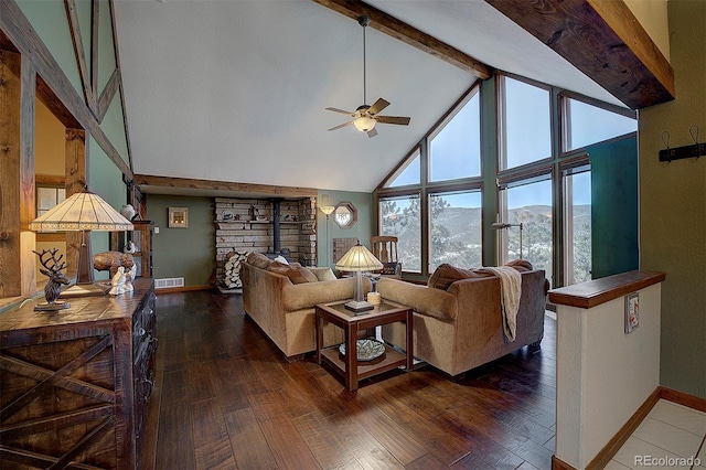 living room with a mountain view, dark wood-type flooring, high vaulted ceiling, and ceiling fan