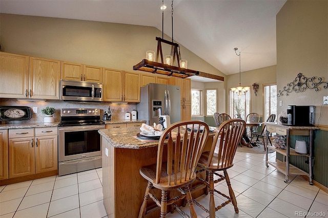 kitchen with light tile patterned flooring, high vaulted ceiling, hanging light fixtures, appliances with stainless steel finishes, and a notable chandelier