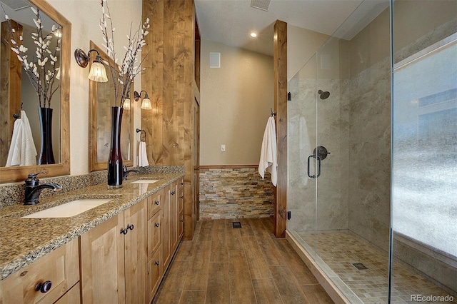 bathroom with vaulted ceiling, vanity, and a shower with door