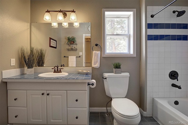 full bathroom with vanity, toilet, tiled shower / bath combo, and tile patterned flooring