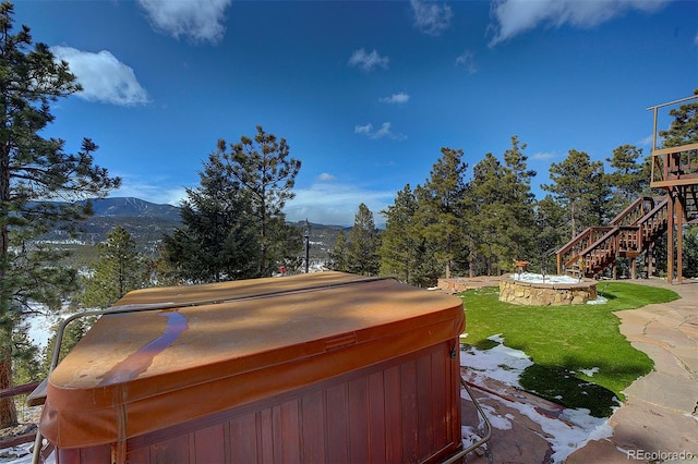 view of yard with a pool with hot tub and a mountain view