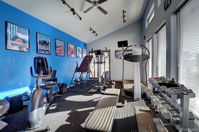 exercise room with ceiling fan, track lighting, and vaulted ceiling