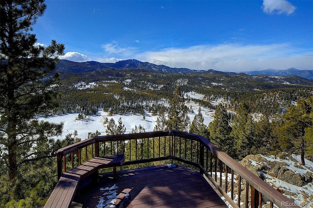 snow covered deck featuring a mountain view