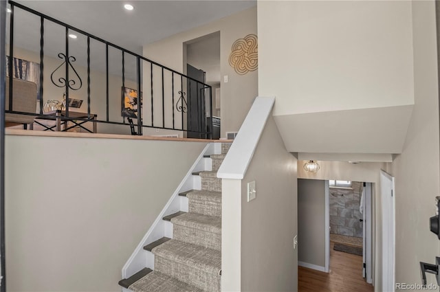 stairs featuring recessed lighting, baseboards, and wood finished floors