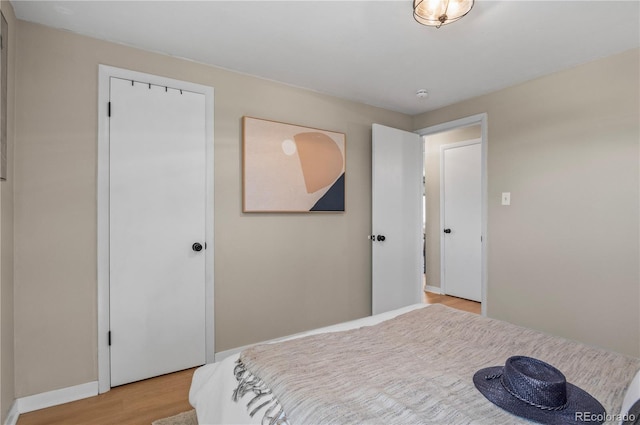 bedroom featuring light wood-style flooring and baseboards
