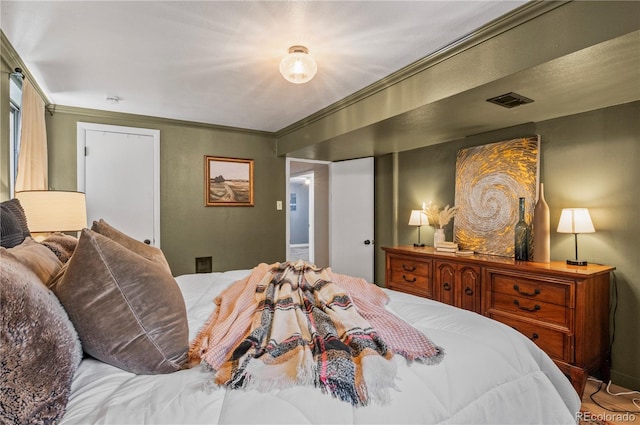 bedroom with visible vents and ornamental molding
