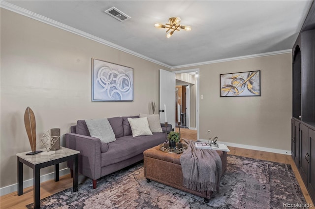 living room featuring crown molding, visible vents, baseboards, and wood finished floors