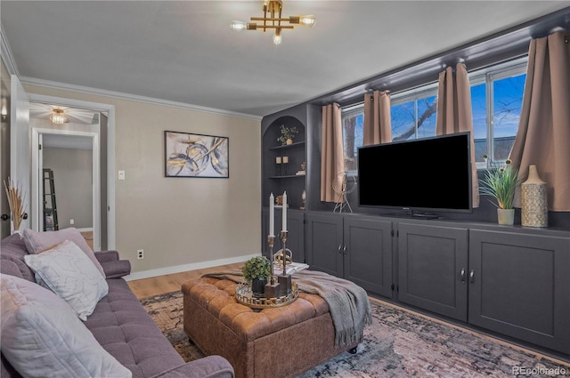 living area with built in features, baseboards, ornamental molding, and wood finished floors