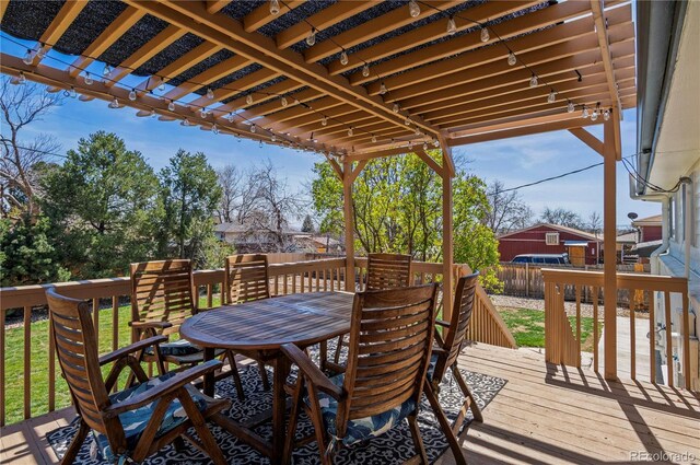 wooden deck featuring fence, outdoor dining area, and a pergola