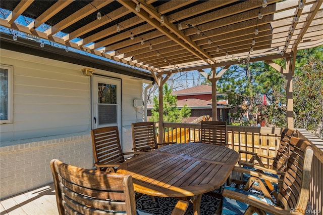 deck featuring a pergola and outdoor dining space