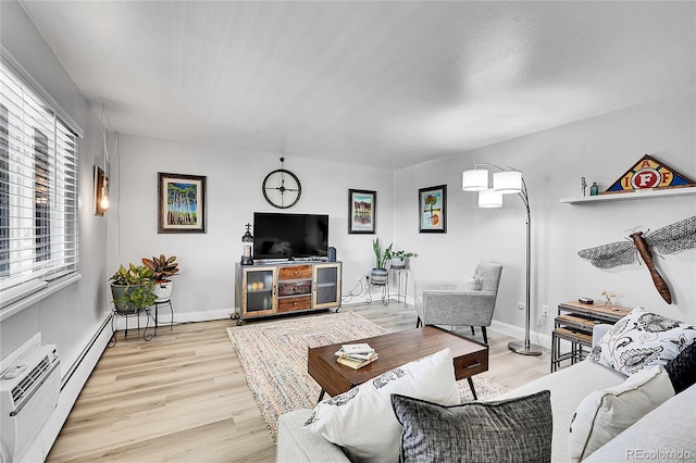 living room with a baseboard radiator and light wood-type flooring