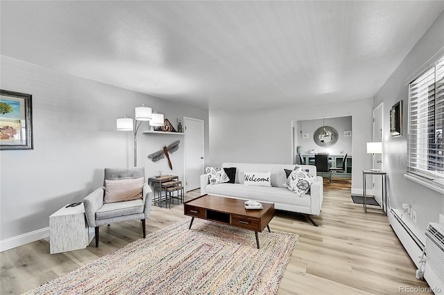 living room with light hardwood / wood-style floors and a baseboard radiator