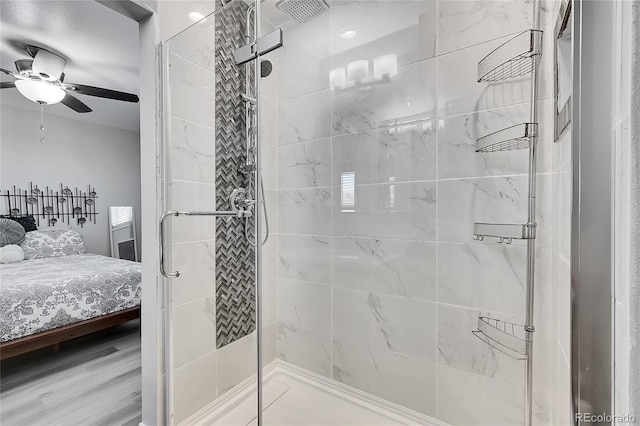 bathroom featuring a shower with door, ceiling fan, and hardwood / wood-style flooring