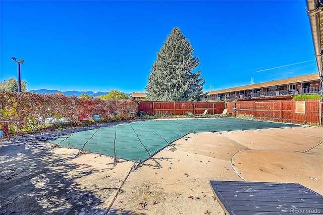 view of pool featuring a patio and a mountain view