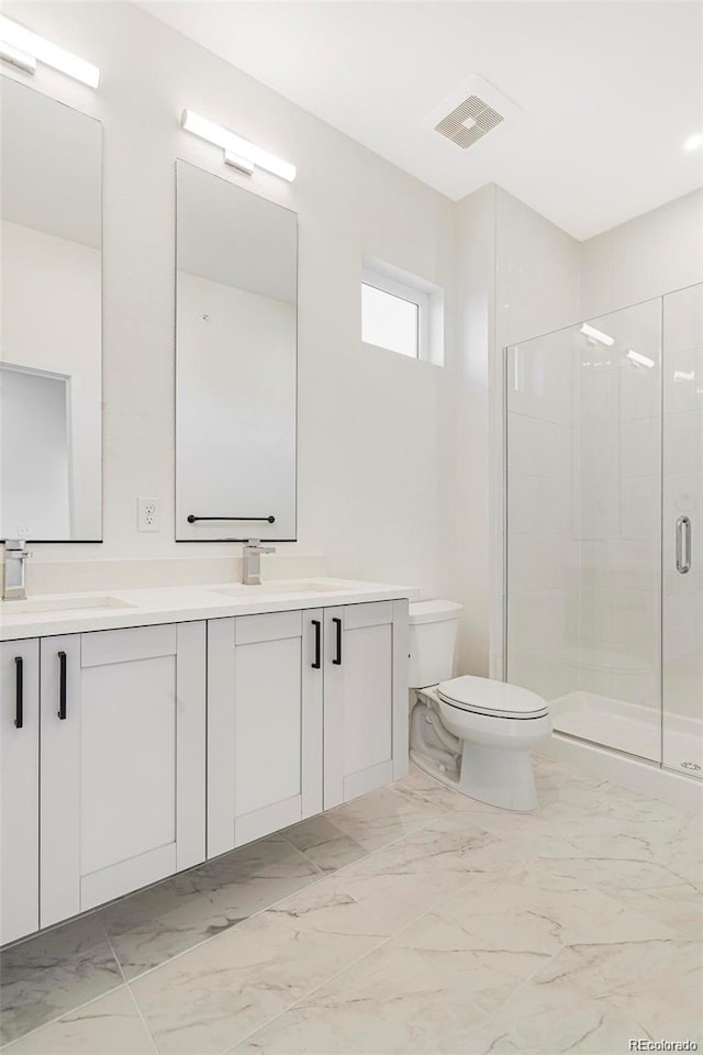 bathroom with a shower with door, vanity, and toilet