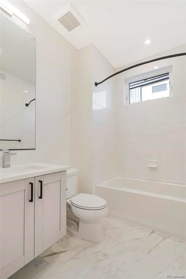 full bathroom featuring toilet, vanity, and tiled shower / bath