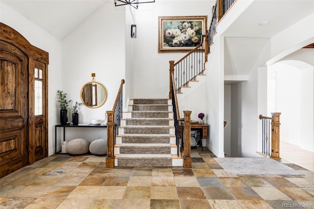 foyer featuring high vaulted ceiling