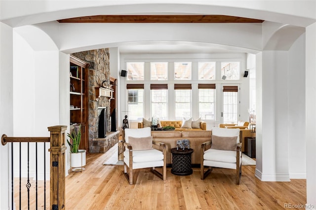 living area with light hardwood / wood-style floors and a fireplace