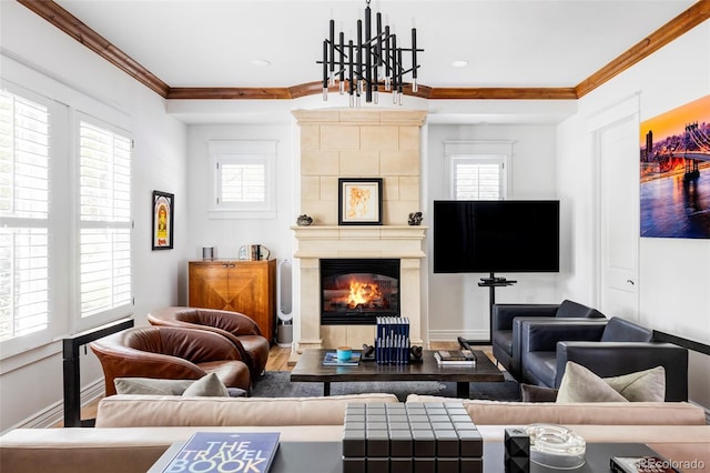 living room featuring wood-type flooring, a tile fireplace, and ornamental molding