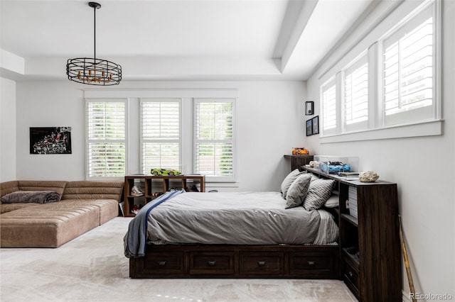 bedroom with multiple windows and an inviting chandelier