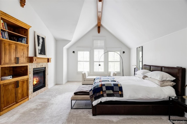 carpeted bedroom with a fireplace and vaulted ceiling with beams