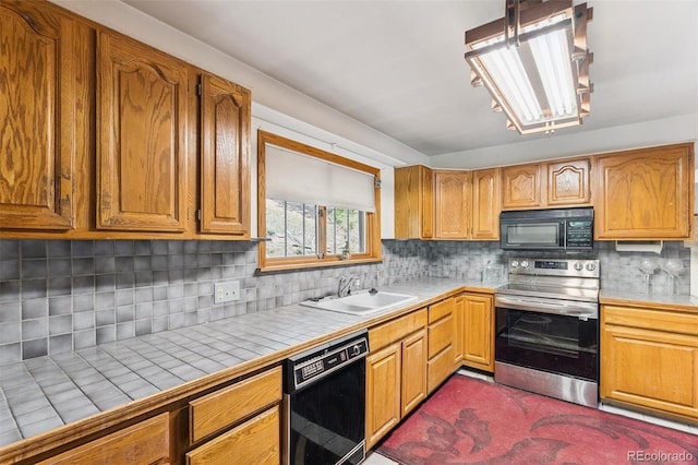 3909 County Road 72, Bailey, CO 80421 - kitchen featuring black appliances, tile countertops, tasteful backsplash, and brown cabinetry