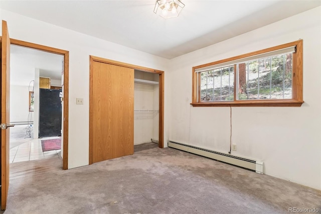 3909 County Road 72, Bailey, CO 80421 - unfurnished bedroom featuring a baseboard heating unit, carpet floors, a closet, and fridge