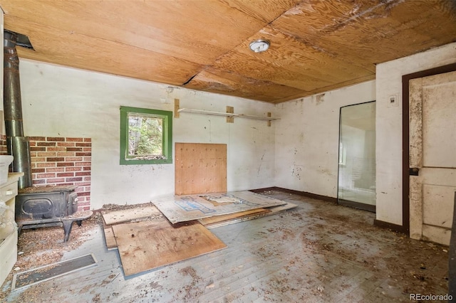 3909 County Road 72, Bailey, CO 80421 - unfurnished living room featuring wood ceiling and a wood stove