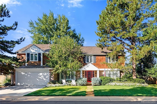 view of front of property featuring a garage and a front yard