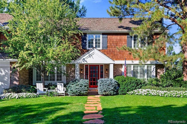 view of front of home featuring a front lawn and french doors