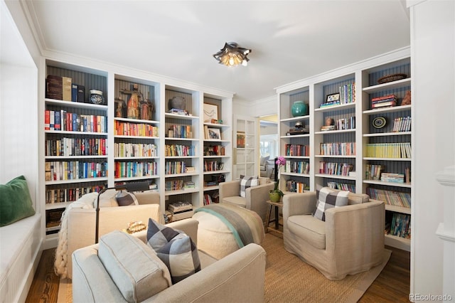 living area with crown molding and wood-type flooring