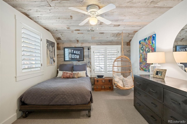 bedroom with wood ceiling, vaulted ceiling, ceiling fan, and light carpet