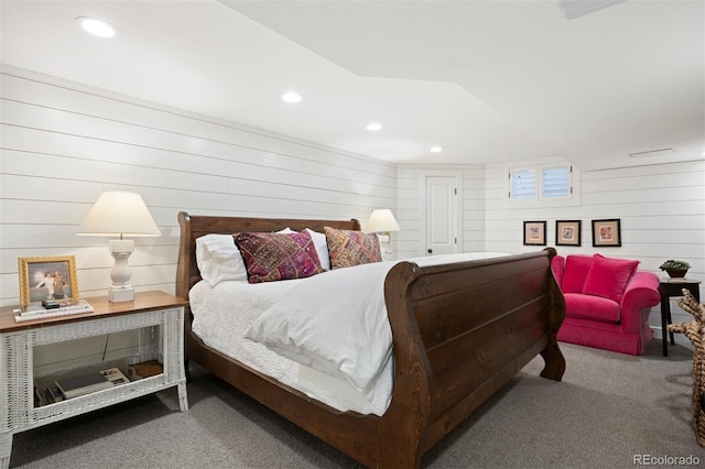 bedroom with wooden walls and carpet flooring