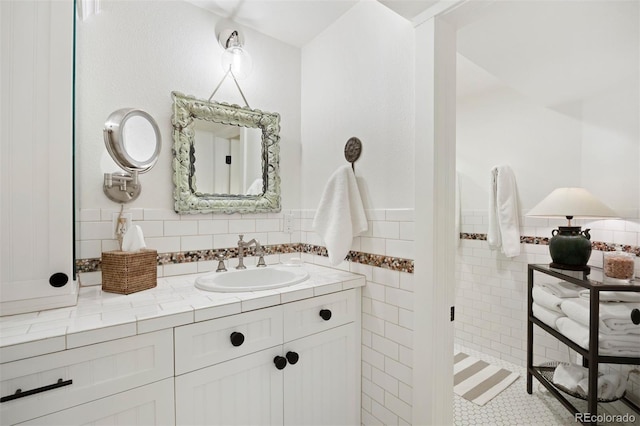 bathroom featuring tile walls, vanity, and tile patterned flooring