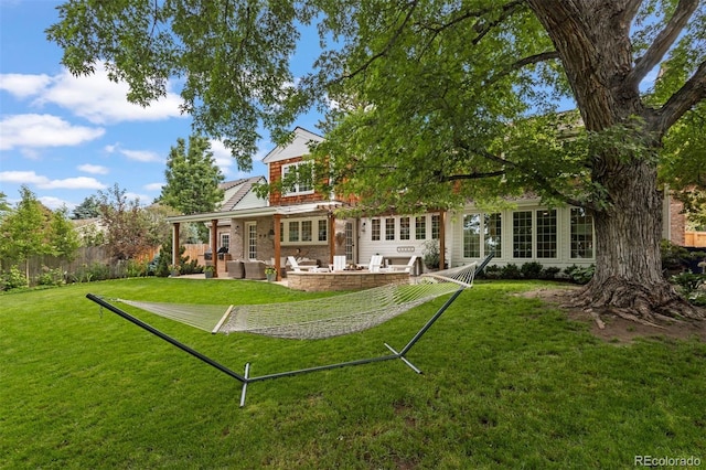 rear view of property featuring a lawn