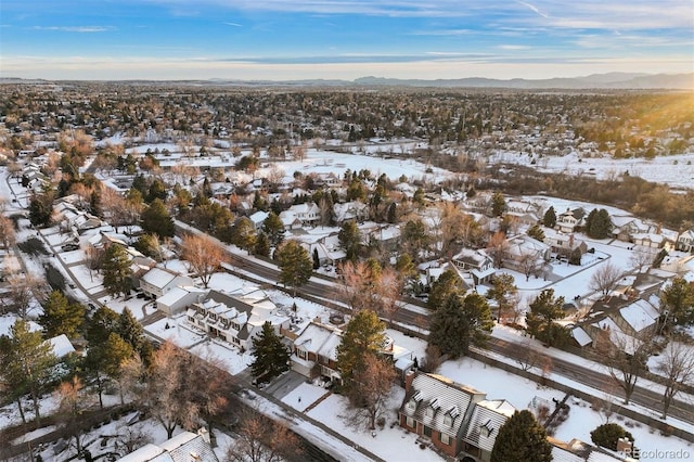 snowy aerial view with a mountain view