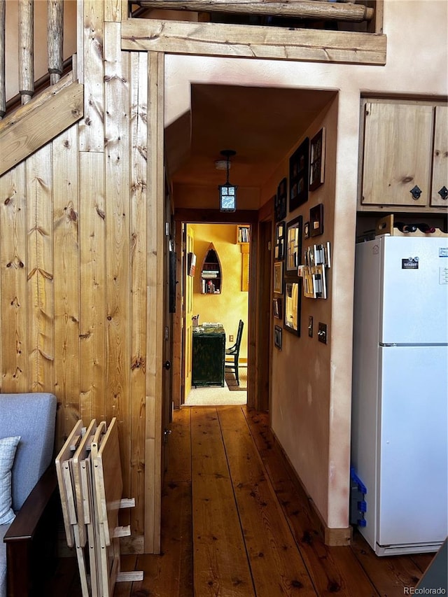 hall featuring hardwood / wood-style flooring and wood walls