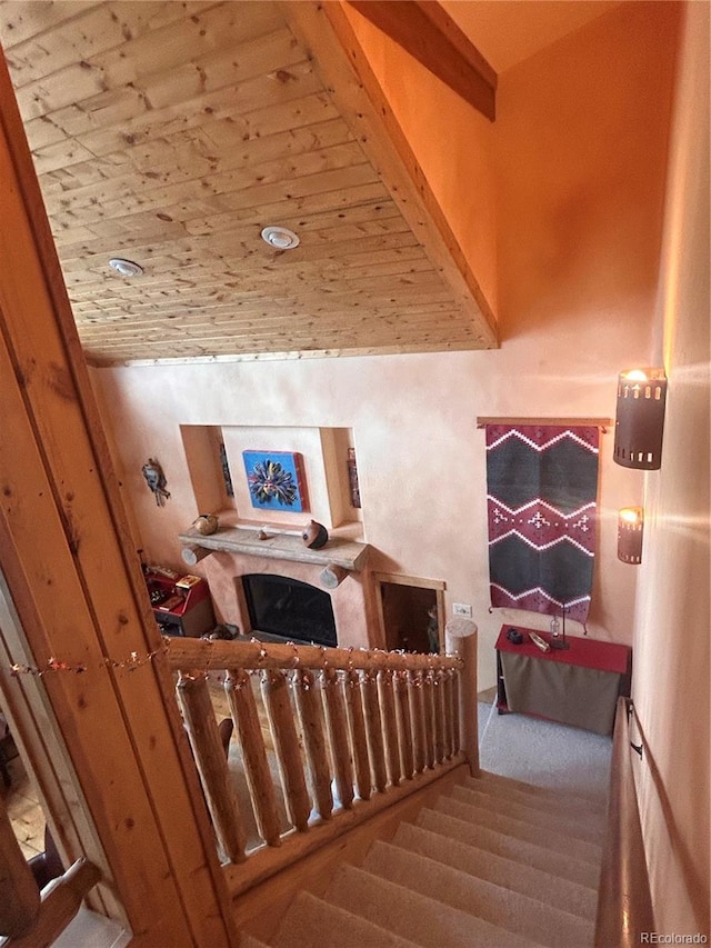 stairway with carpet floors and a fireplace