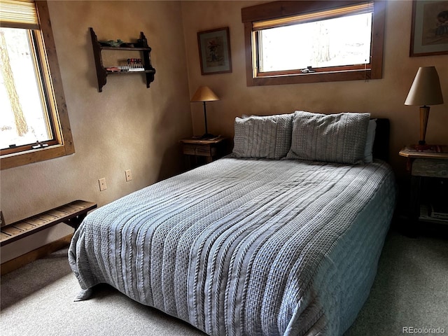 bedroom featuring carpet and a textured wall