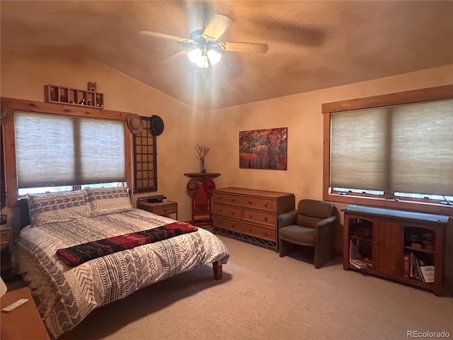 bedroom featuring lofted ceiling, carpet floors, and a ceiling fan