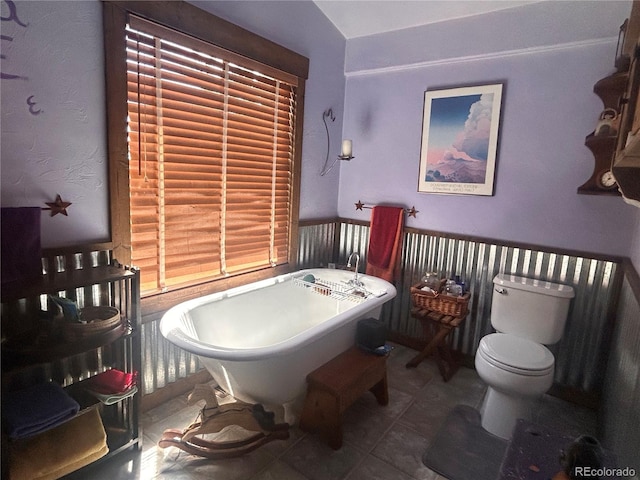 bathroom featuring a freestanding bath and tile patterned flooring