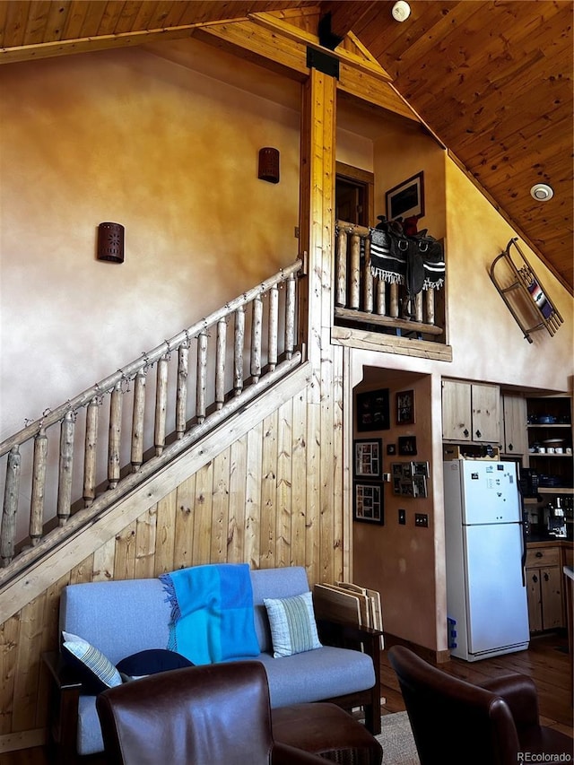 stairs featuring wood ceiling and high vaulted ceiling