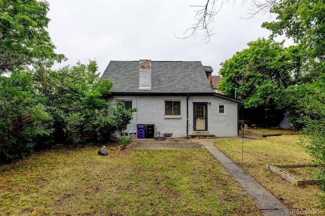 1707 W 39th Ave, Denver, CO 80211 - back of house featuring a garden, a shingled roof, a lawn, and brick siding