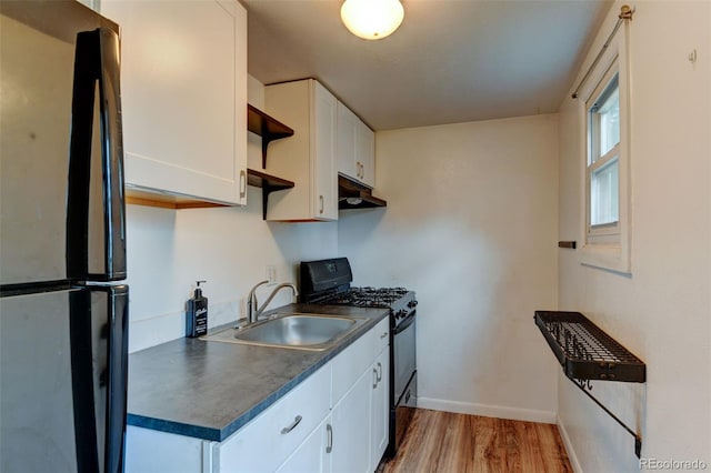 1707 W 39th Ave, Denver, CO 80211 - kitchen featuring freestanding refrigerator, gas stove, under cabinet range hood, dark countertops, and open shelves