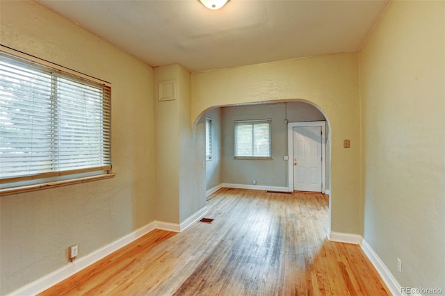 1707 W 39th Ave, Denver, CO 80211 - empty room with arched walkways and wood finished floors